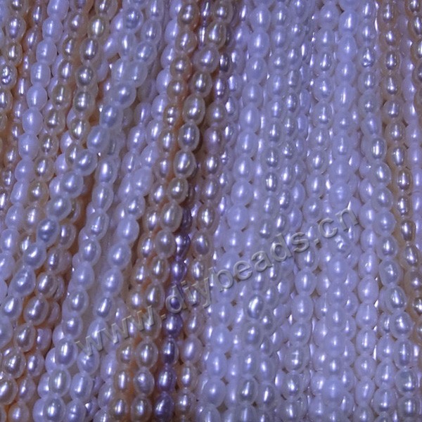 Pearl, cultured freshwater,white pink,2-3mm rice, AA grade. Sold per bag of one strand
