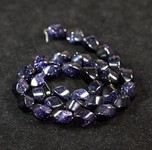 Bead, blue goldstone (manmade), 10x12mm twisted oval. Sold per 16-inch strand