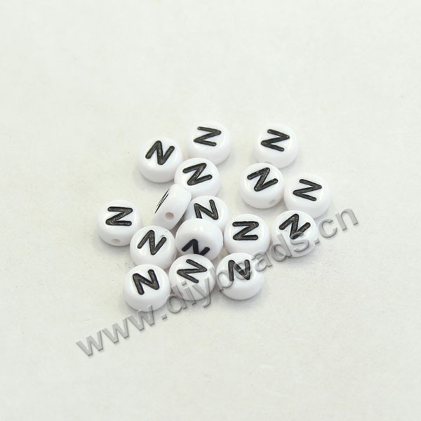 Bead mix, acrylic, white with black alphabet N, 7x4mm double-sided flat round with 1.2mm drill hole. Sold per pkg of 100ps