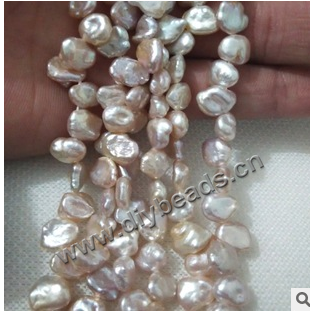 Pearl,cultured freshwater,white,9-10mm rice,half hole, AAgrade. Sold per pkg of 1 strand