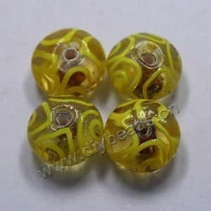 Bead,lampworked glass, clear and yellow with gold-colored foil painted swirls, 16x10mm rondelle. Sold per pkg of 500.