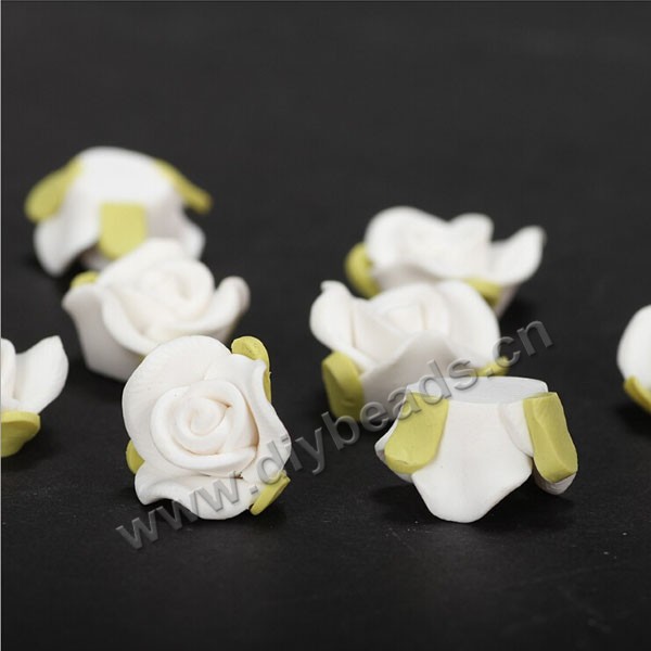 Bead, polymer clay,white with green leaf,15x10mm flower. Sold per pkg of 5.