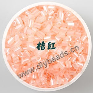 Bugle bead, glass,silky luster,light orange,#1 (3x2mm)beads. Sold per pkg of 80 grams,approximately 4,500ps.