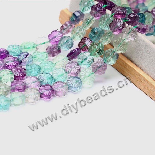 Bead, rainbow fluorite (natural), 10mm carved flower, A grade. Sold per 15-inch strand.