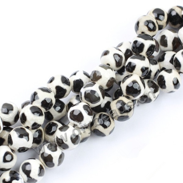 Bead, agate, 8mm faceted round, black with white, football shape. Sold per 15-inch strand.