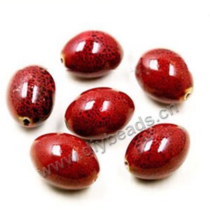 Bead, porcelain, red, 27x20mm oval. Sold per pkg of 30 beads.