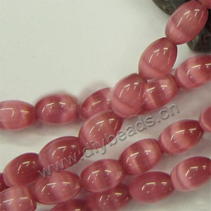 Bead, cat's eye glass,peach ,12x8mm oval. Sold 15-inch strands.