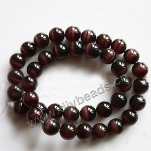 Bead, cat's eye glass,purple, 10mm round, quality grade. Sold per (3) 14.5-inch strands.