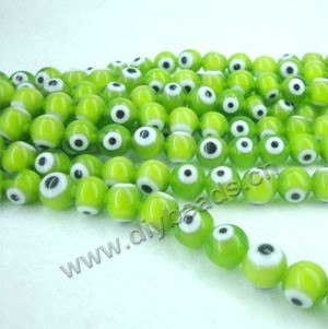 Bead , lampworked glass, opaque green, 10mm double-sided round with wards off the evil eye design. Sold per pkg of (4) 15-inch strand.