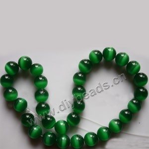 Bead, cat's eye glass,green, 12mm round, quality grade. Sold per 14.5-inch strand.