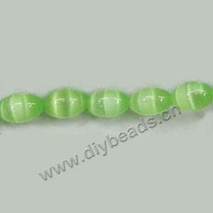 Bead, cat's eye glass,light green ,10x7mm oval. Sold per 15-inch strand.