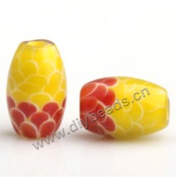 Bead,lampworked glass,red with yellow, 15*10mm oval with fish scale design. Sold per pkg of 5.