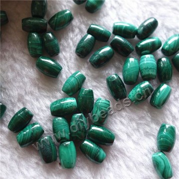 Bead, malachite (natural),7x10mm rice shape. Sold per pkg of 50pcs