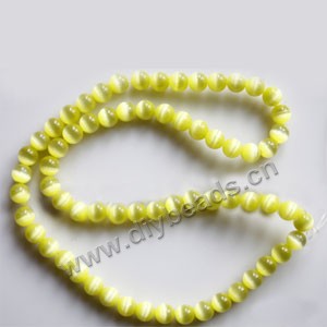 Bead, cat's eye glass,yellow, 6mm round, quality grade. Sold per 14.5-inch strand.