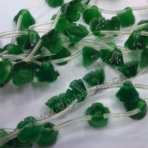 Bead, cat's eye glass,  green, 9x12mm carved flower. Sold per 16-inch strand.approximately 8 beads.