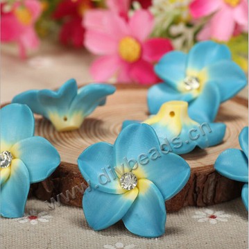 Bead, polymer clay,blue with rhinestone ,30x12mm flower. Sold per pkg of 20.