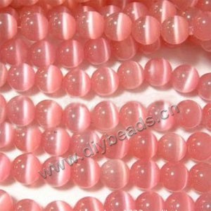 Bead, cat's eye glass,pink, 8mm round, quality grade. Sold per 14.5-inch strand.
