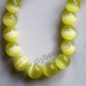 Bead, cat's eye glass,yellow, 12mm round, quality grade. Sold (10) 14.5-inch strands.