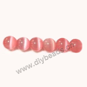 Bead, cat's eye glass,pink, 10mm round, quality grade. Sold per 14.5-inch strand.