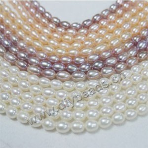 Pearl mix, cultured freshwater pearl (natural), white / peach / mauve,6-7mm rice,A- grade. Sold per pkg of (10) 15-inch strands.