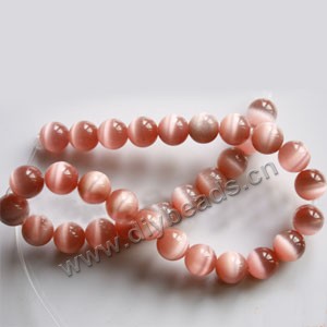 Bead, cat's eye glass,pink, 12mm round, quality grade. Sold per 14.5-inch strand.