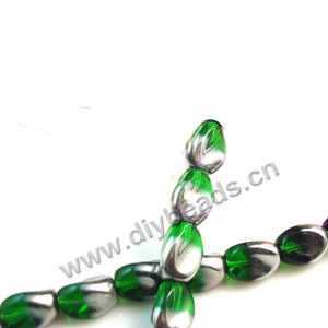 Bead ,silver-plated glass, green, 13x10mm twisted oval. Sold per pkg of ten 30cm strand.