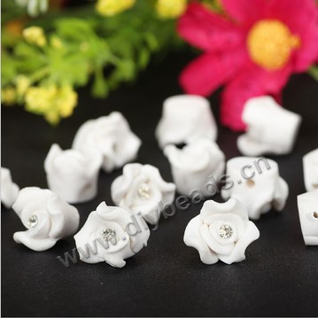 Bead, polymer clay,white with rhinestone ,8x4mm flower. Sold per pkg of 5.