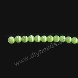 Bead, cat's eye glass,peridot, 8mm round, quality grade. Sold per 14.5-inch strand.