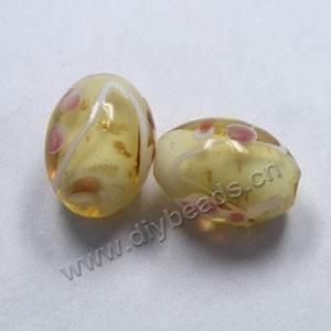Bead, lampworked glass, light amber with flowers, 18x14mm barrel. Sold per pkg of 300.
