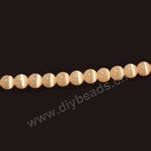 Bead, cat's eye glass,light orange, 8mm round, quality grade. Sold per 14.5-inch strand.