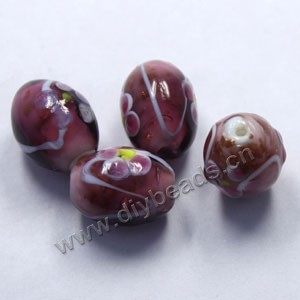 Bead, lampworked glass, purple with flowers, 18x14mm barrel. Sold per pkg of 300.