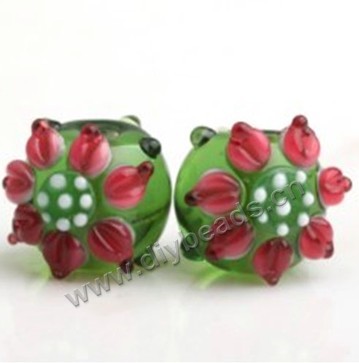 Bead,lampworked glass,green, 12*14mm round with sunflower. Sold per pkg of 5.
