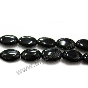 Bead, black agate (dyed), 12x10mm flat oval. Sold per 16-inch strand.