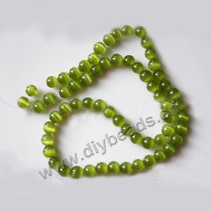 Bead, cat's eye glass,grass green, 6mm round, quality grade. Sold per 14.5-inch strand.