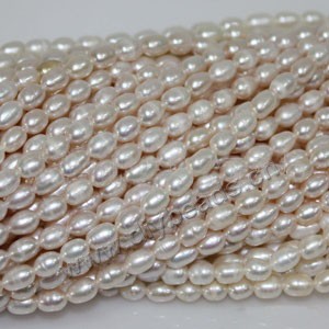 Pearl, cultured freshwater (natural), white/peach/mauve, 6-7mm rice, C grade. Sold per pkg of (20)16-inch strands.