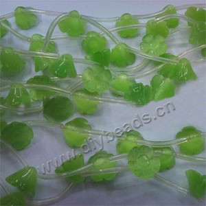 Bead, cat's eye glass,  light green, 9x12mm carved flower. Sold per 16-inch strand.approximately 8 beads.