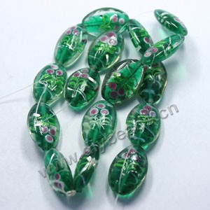 Bead, lampworked glass,clear/green/pink, 26x18mm puffed oval with painted flower and silver swirls. Sold per pkg of 300.