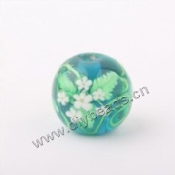 Bead, lampworked glass,green with flower, 14x14mm round.mini order 50pc 