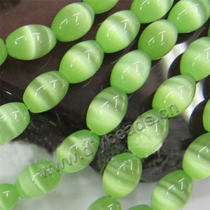 Bead, cat's eye glass,light green ,12x8mm oval. Sold  (10) 15-inch strands.