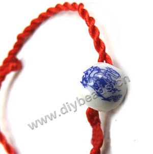 Cord, nylon with smooth satin finish, red, 2.5mm twisted with 11mm pocelain round beads,bracelet componetnts. Sold per pkg of (100)18-20cm strands,factory price