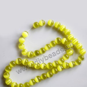Bead, cat's eye glass,yellow, 8mm round, quality grade. Sold per 14.5-inch strand.